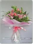 Pink roses and lilies with greens bundled with ribbon. This bouquet is a terrific way to send your best wishes. 