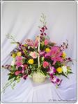Yellow roses, pink Stargazer lilies, and purple orchids mix with pink carnations and a sorted greenery in a basket.  This basket is sure to put a smile on anyone"s face. Approximately 50cm H. Contents may vary depending on availability. 
