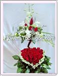 Show her your true feelings with this elegant arrangement. This includes 30 red roses, some orchids, and greens.